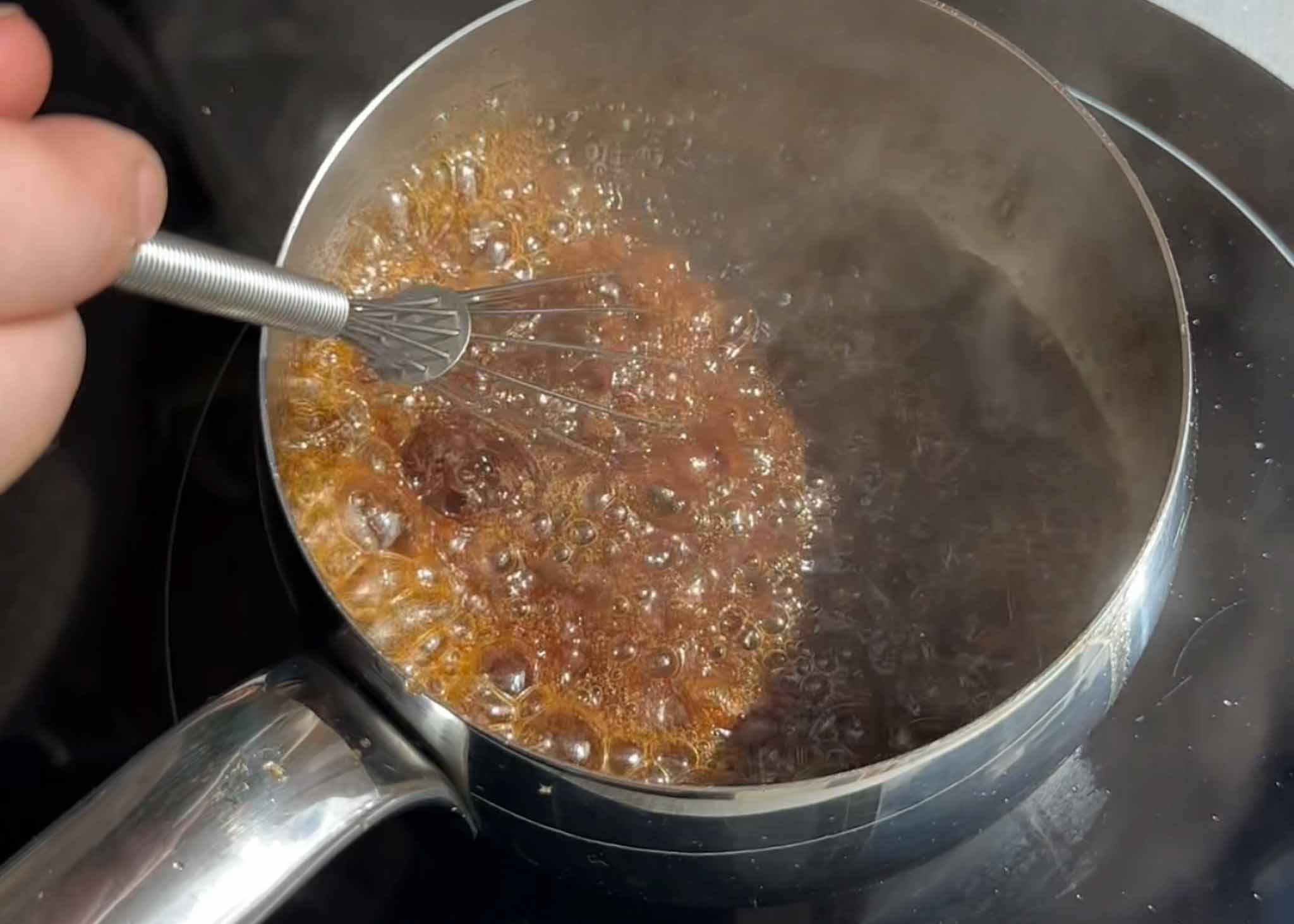 Caramel sauce bubbling in a saucepan