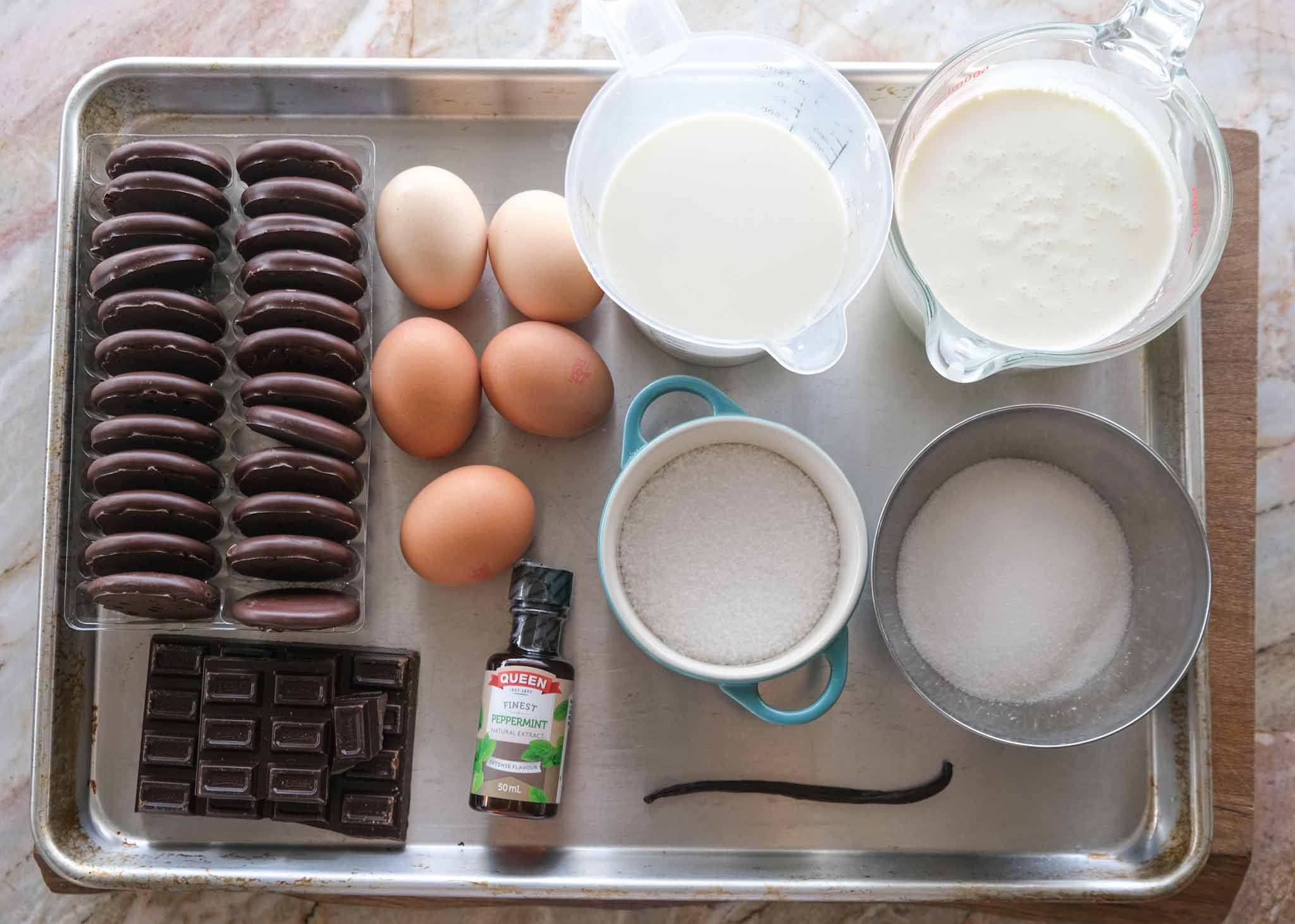 Ingredients for homemade Mint Slice ice cream sandwiches, including Mint Slice biscuits, cream, milk, eggs, chocolate and peppermint extract