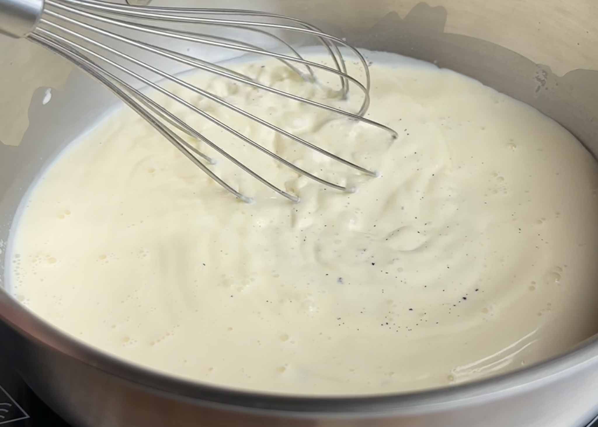 Vanilla ice cream custard cooking in a saucepan
