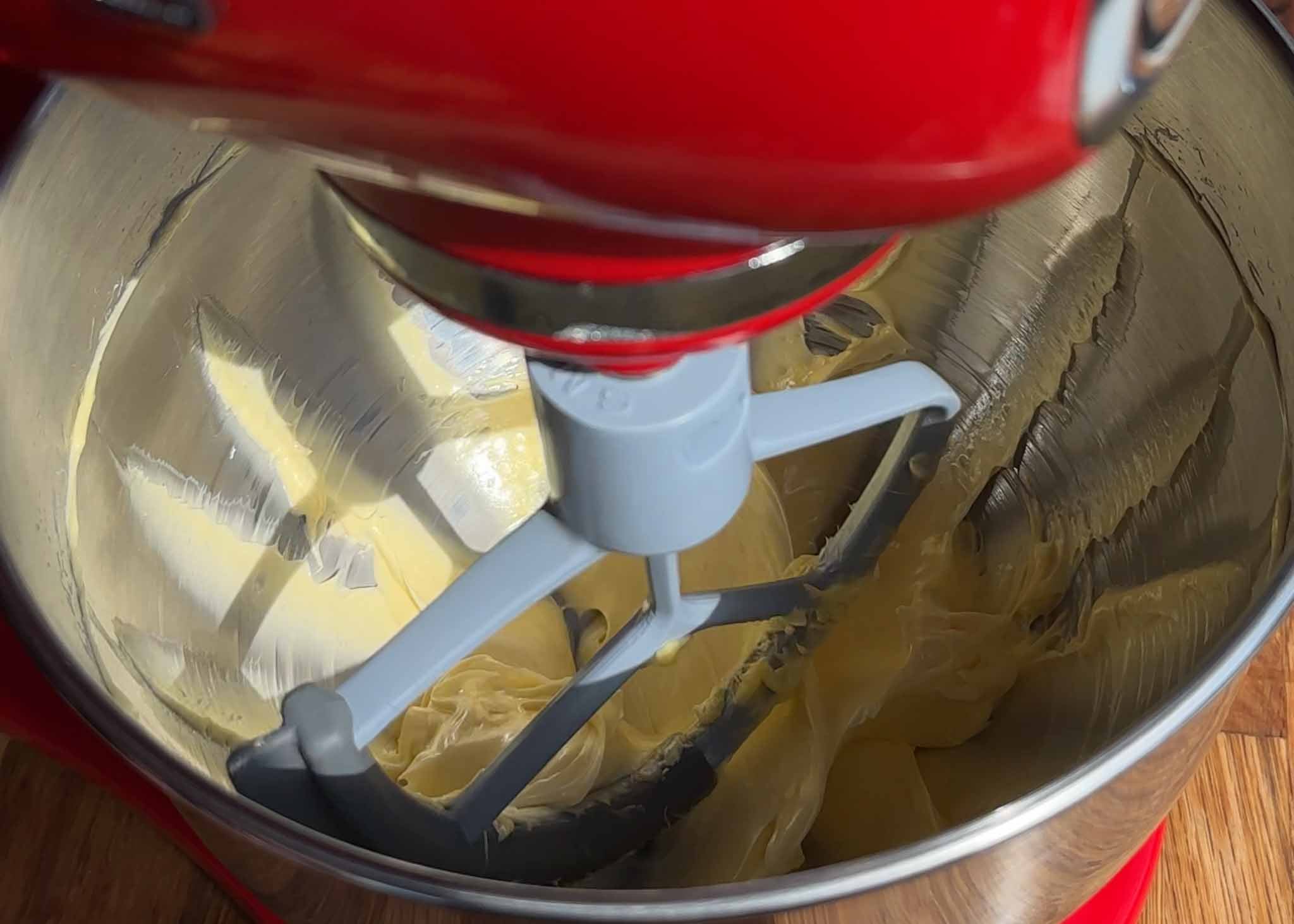 Whipped cream cheese being mixed until smooth and fluffy